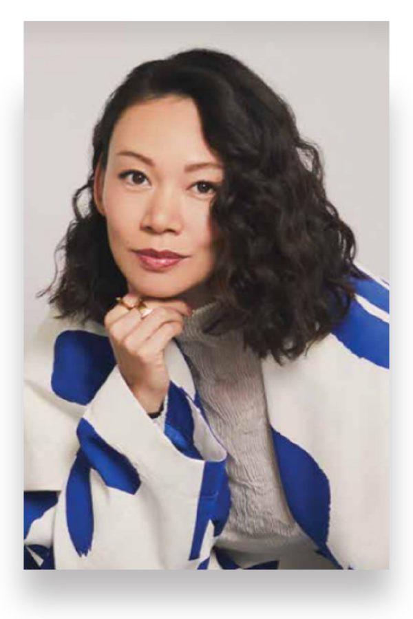 Luxe/Detour founder Jing Zhang poses in a white and blue patterned outfit.