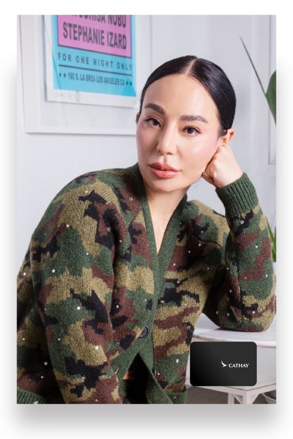 Hong Kong entrepreneur Lindsay Jang sits on a chair and leans her elbow on her computer desk in a portrait.