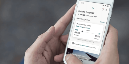 A person holding a mobile and displaying the app screen