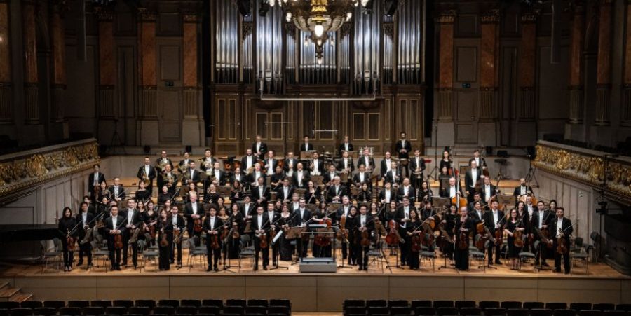 The front view of The Hong Kong Philharmonic Orchestra performing on the stage