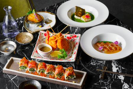 This image shows an elegant cuisine presentation with sushi rolls, skewered fried items, seafood, and creative appetizers, featuring vibrant colors and artistic plating.
