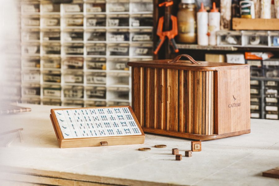 The Cathay x Start From Zero wooden mahjong gift set on table, demostrating the mahjong and the dice inside. 