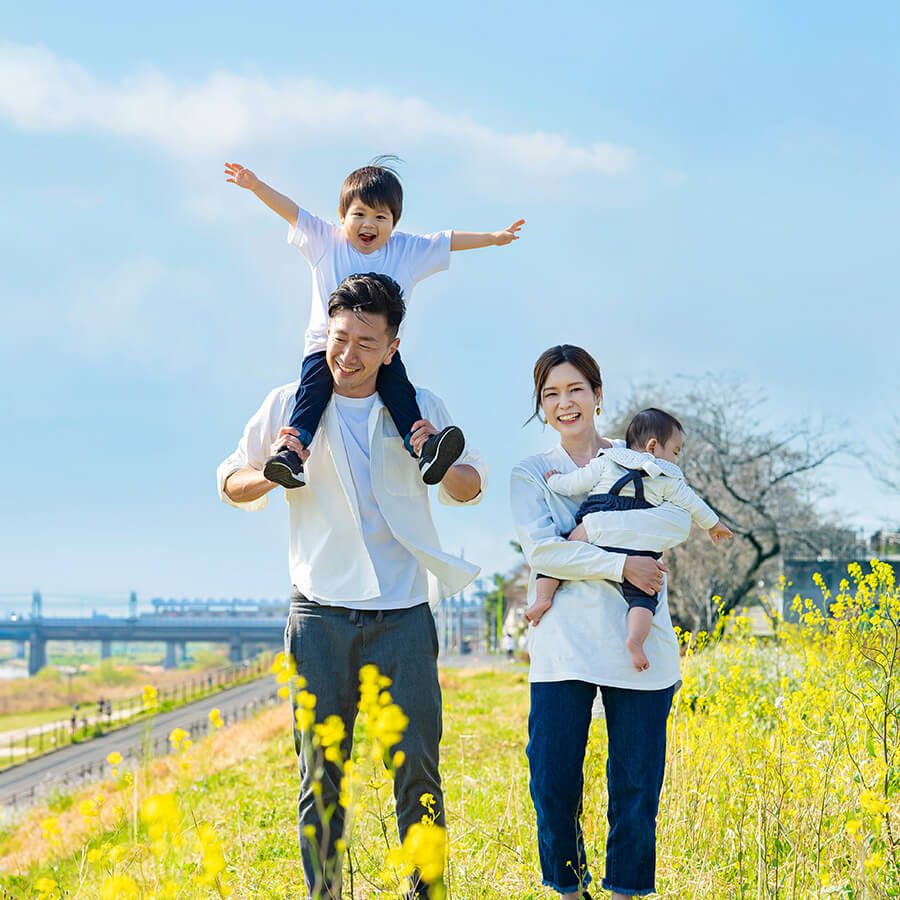 A family of 4 walking by the river