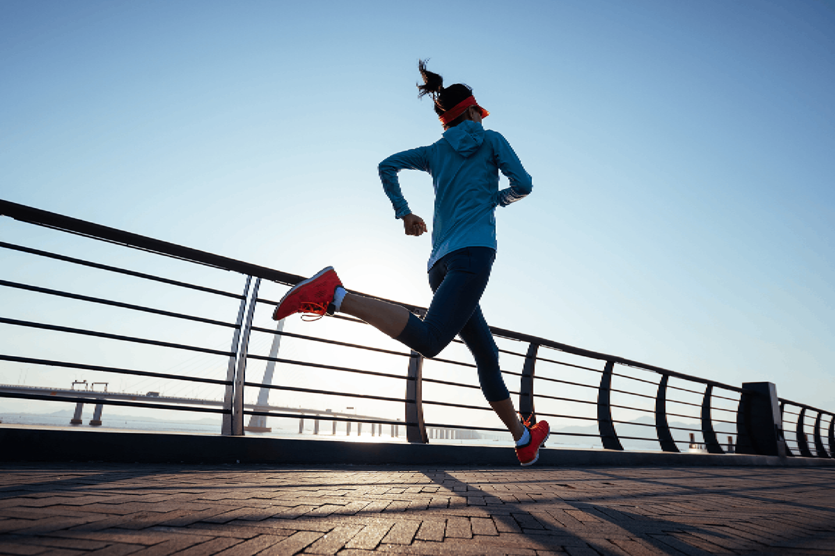 Lady running along Hong Kong island harbour front.  Credit: iStock