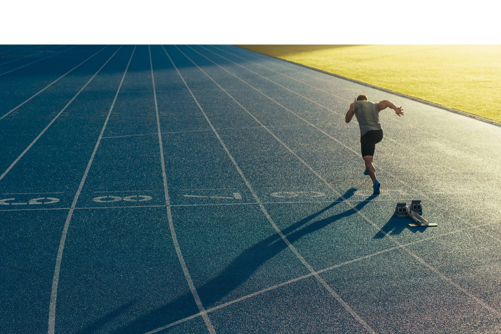 Runner setting off from blocks on a running track