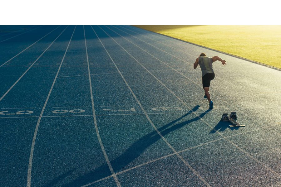 Runner setting off from blocks on a running track