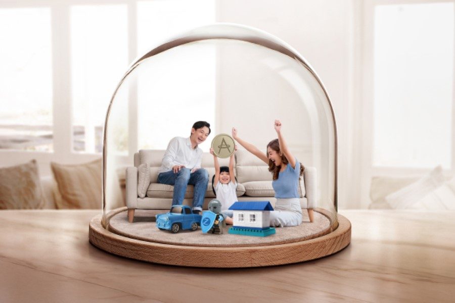 A family sitting on a couch in a glass dome