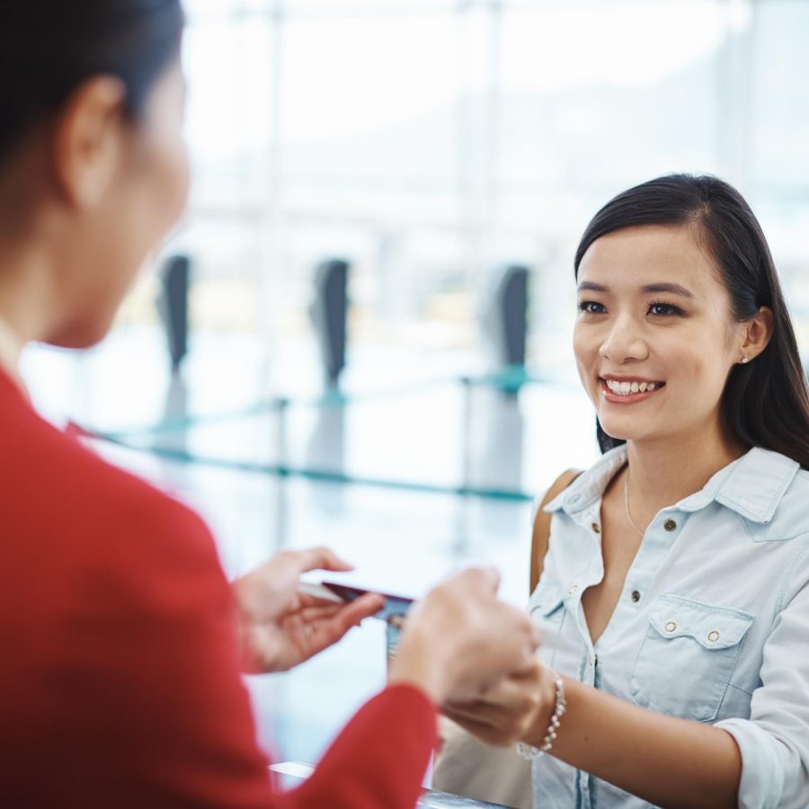 Woman checking in at Premium Economy